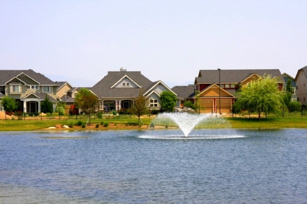 view of houses by a pond