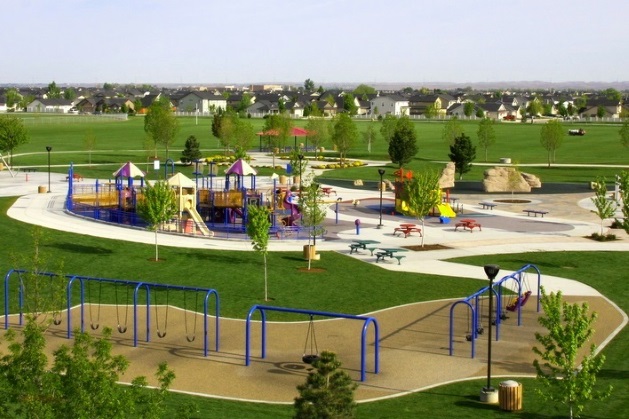 view of playground at Settler's Park with a neighborhood in the distance