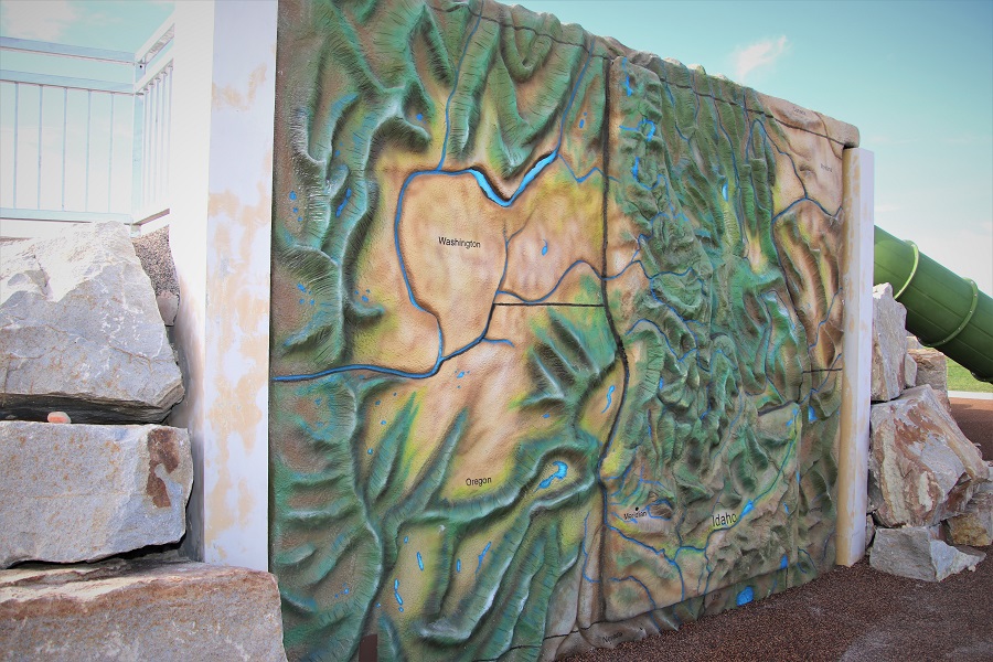 Climbing wall featuring topography of Idaho and parts of neighboring states as hand and footholds at Discovery Park
