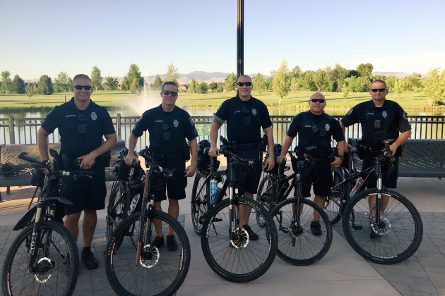 5 police officers standing with their patrol bikes