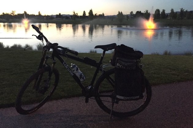 a patrol bike near a pong at sunset
