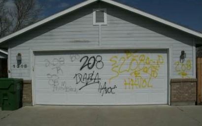 Photo of garage door with graffiti spray painted on it