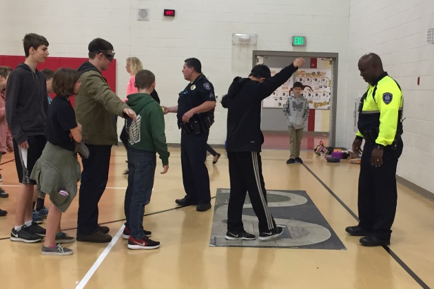 group photo of students with a School Resource Officer