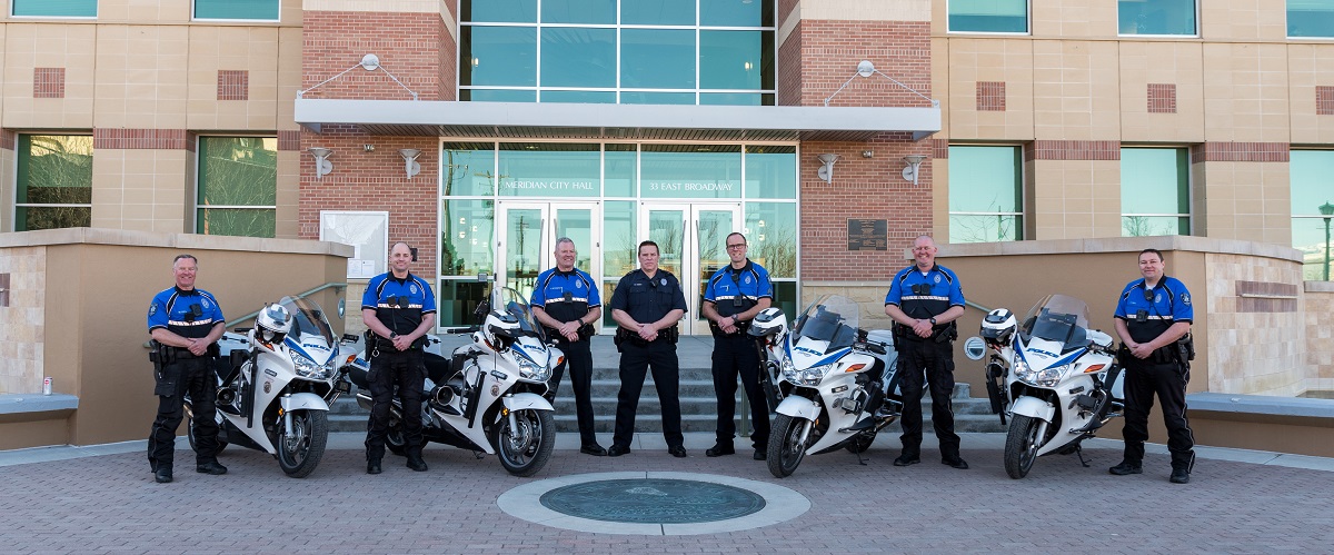 Traffic Team in front of City Hall; 7 police officers standing with 4 police motorcycles